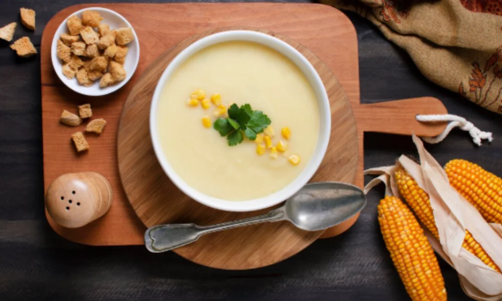 Creamy corn soup garnished with parsley and corn kernels