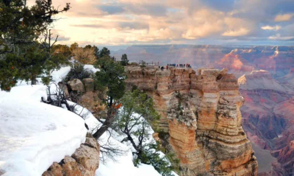 Snow-covered cliffs of the Grand Canyon with evergreen trees-places to visit in arizona