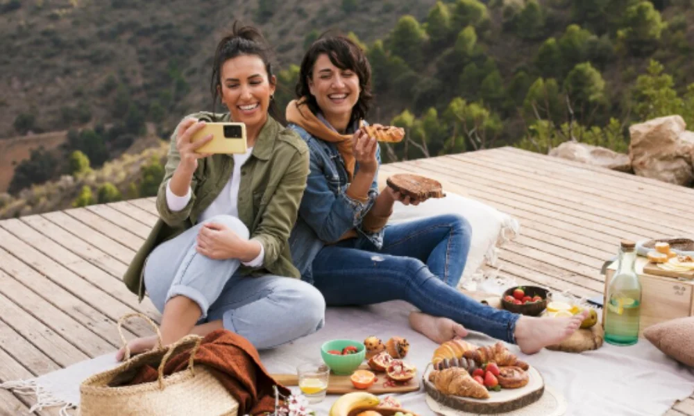  Two women enjoying a picnic on a blanket-new zealand travel guide