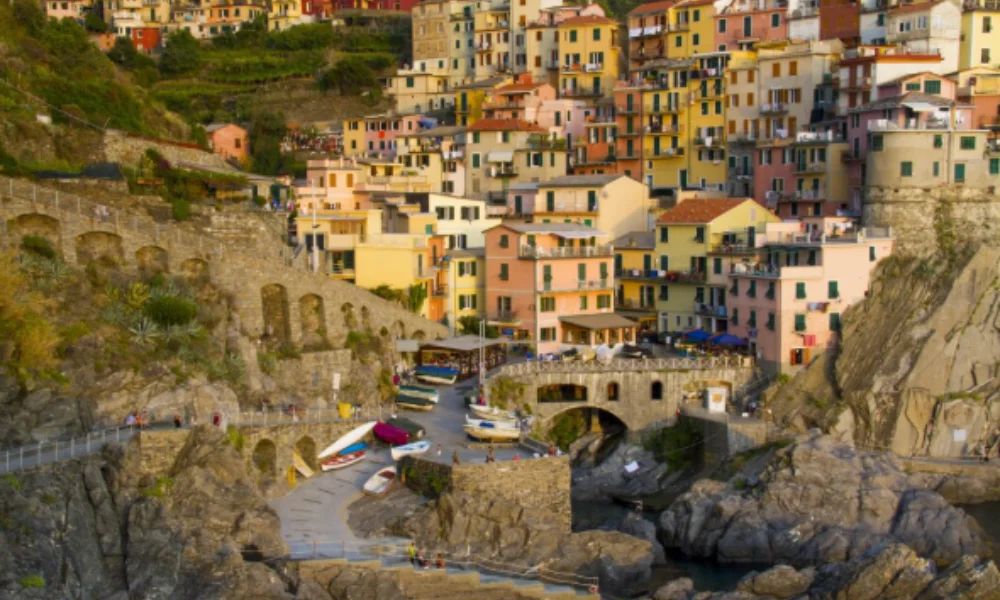 Colorful cliffside village with vibrant houses stacked on rocky terrain