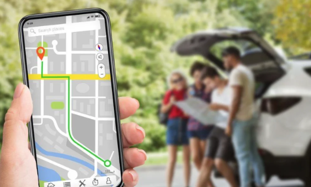 A smartphone displaying a GPS map with a marked route is held up-new york tourist map