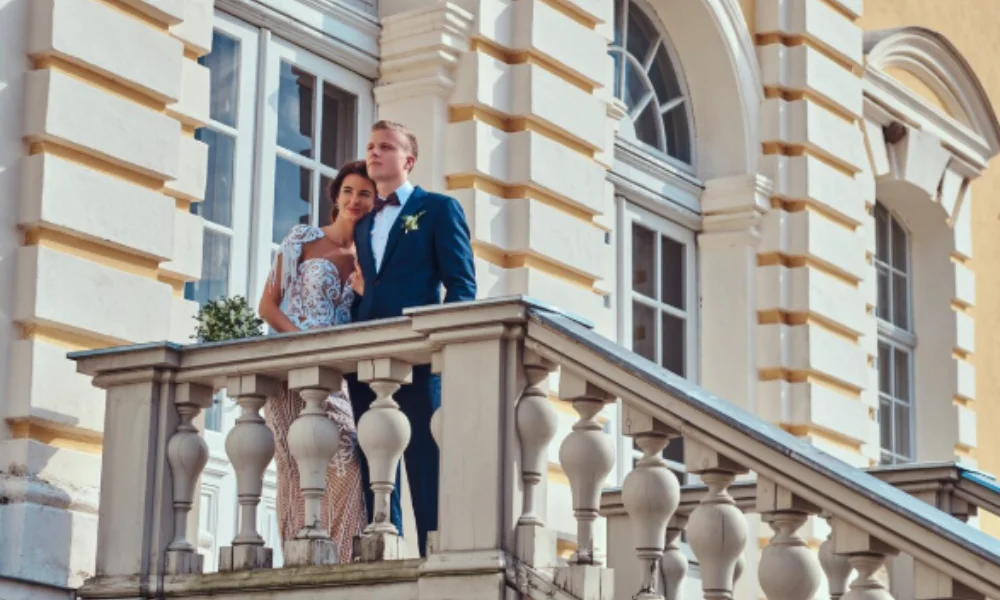 A couple in wedding attire stands on a grand staircase-rick steves paris hotels