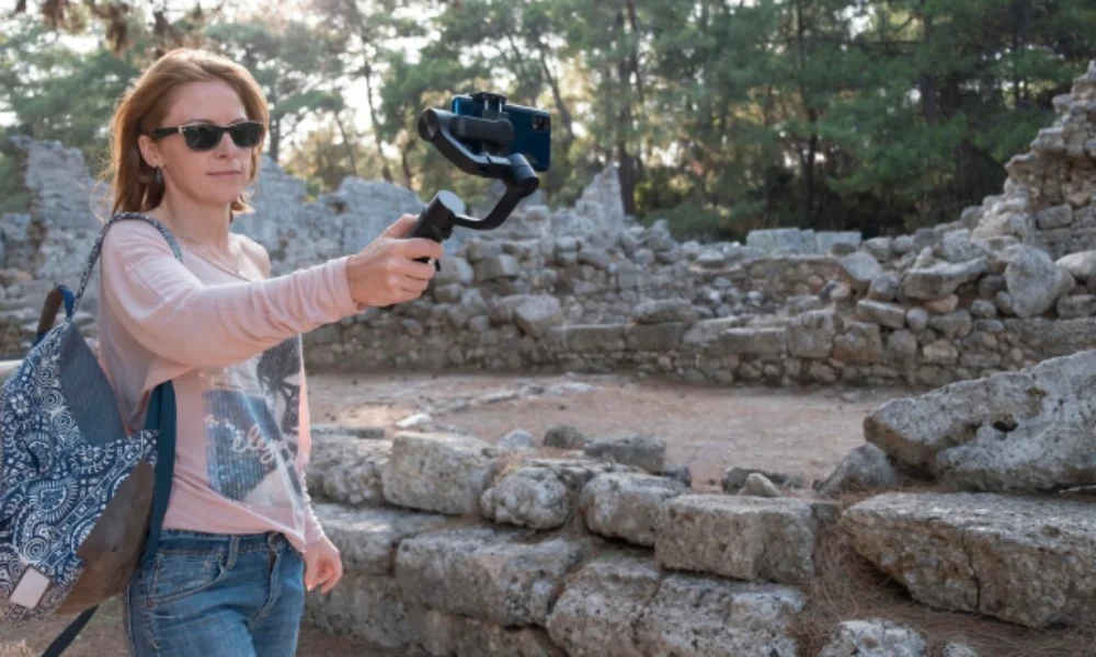 A woman wearing sunglasses and a backpack smiles while taking a selfie-rome travel guide map
