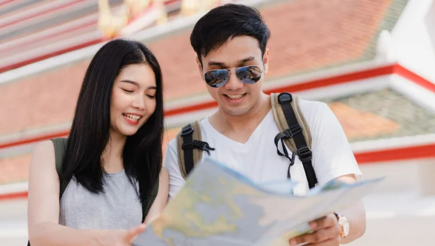 girl and boy  heaving the  map 