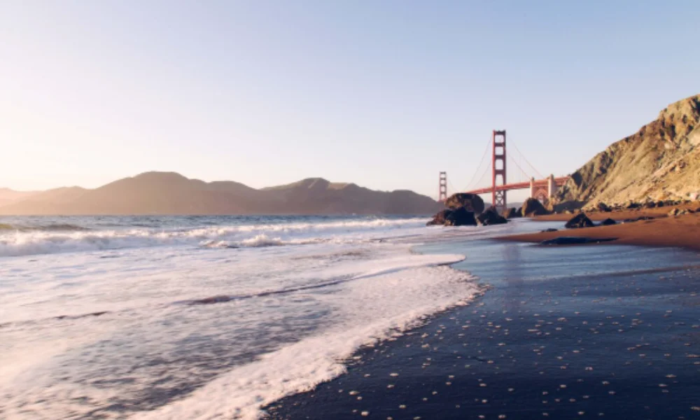 Sunset view of a sandy beach with gentle waves