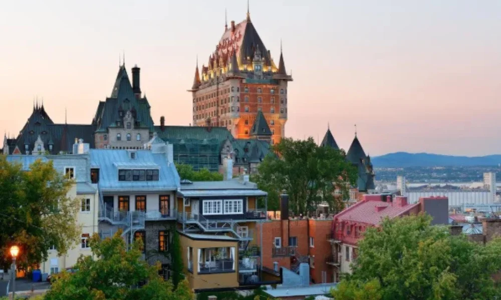 Sunset view of Old Quebec City with Château Frontenac's spires rising above historic buildings