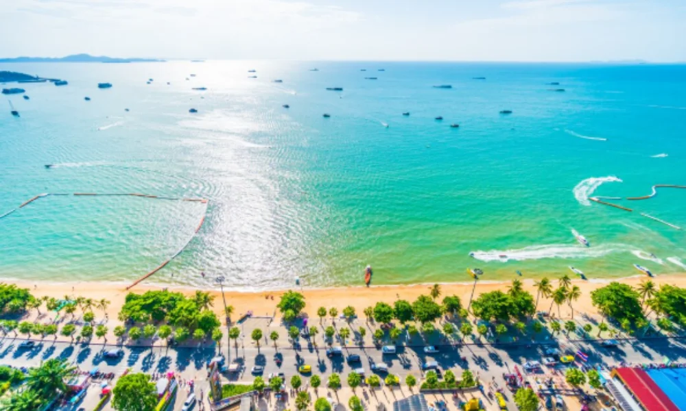 Aerial view of a vibrant beach with turquoise waters, jet skis, and boats-places to visit in vietnam