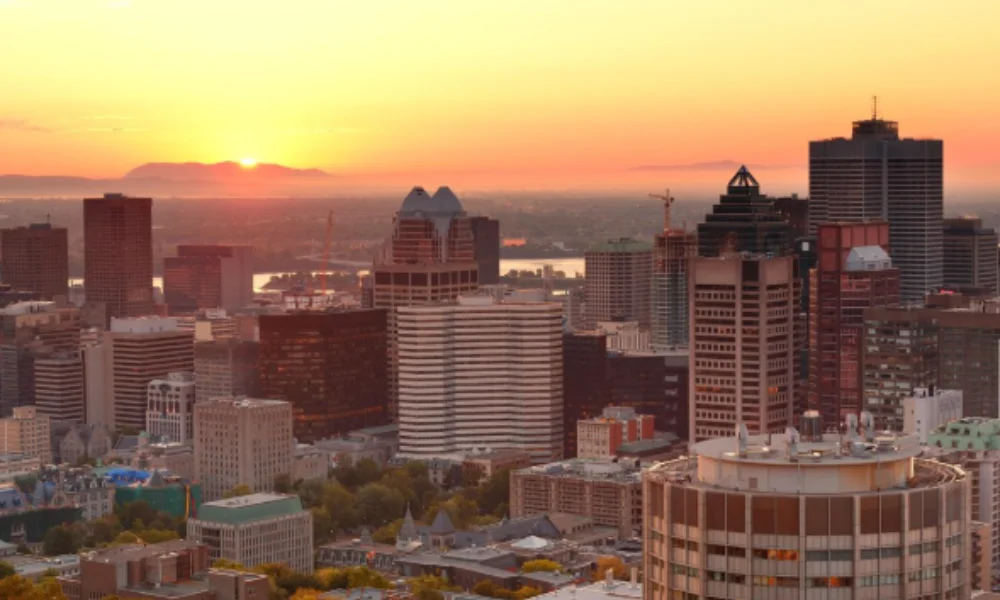 City skyline at sunset with high-rise buildings silhouetted against a vibrant orange sky-colorado places to visit