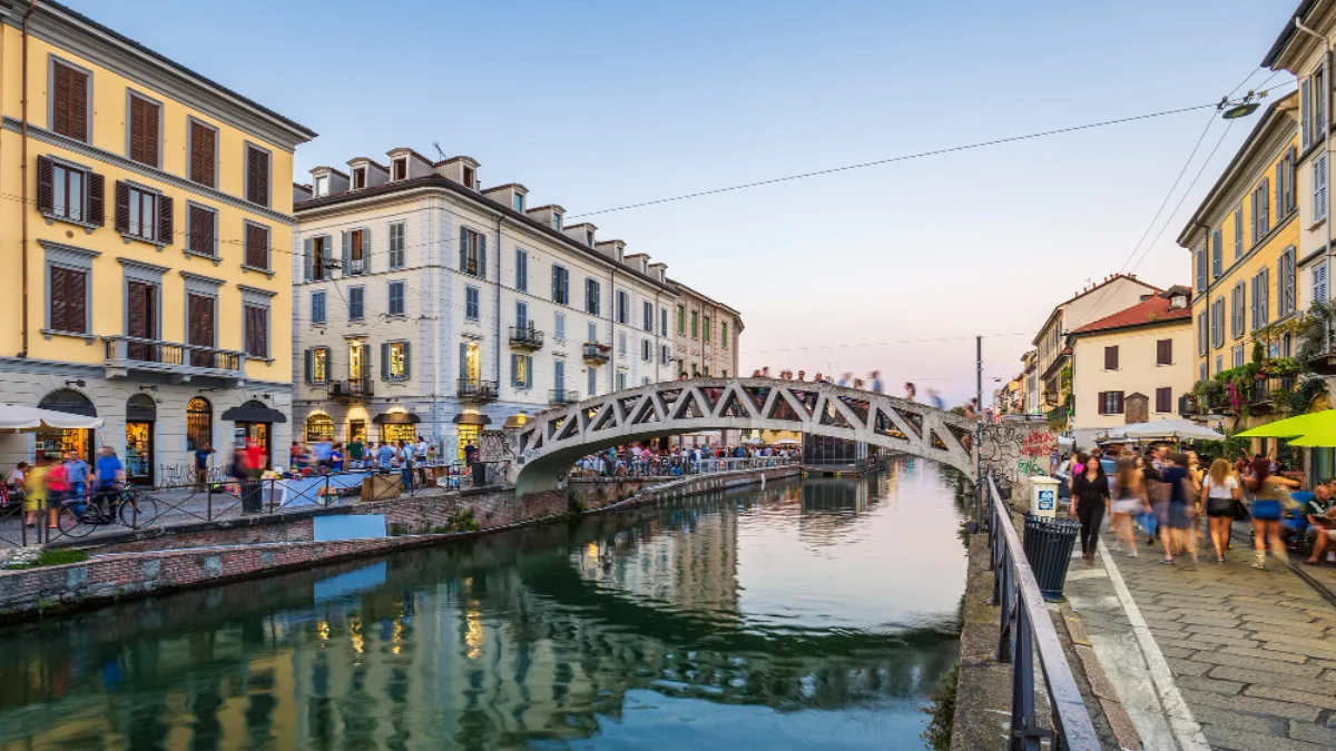 A picturesque canal scene in Milan's Navigli district at sunset