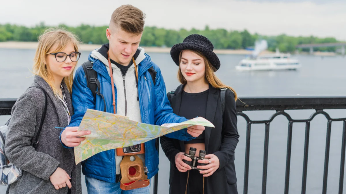 Three young people studying a map together