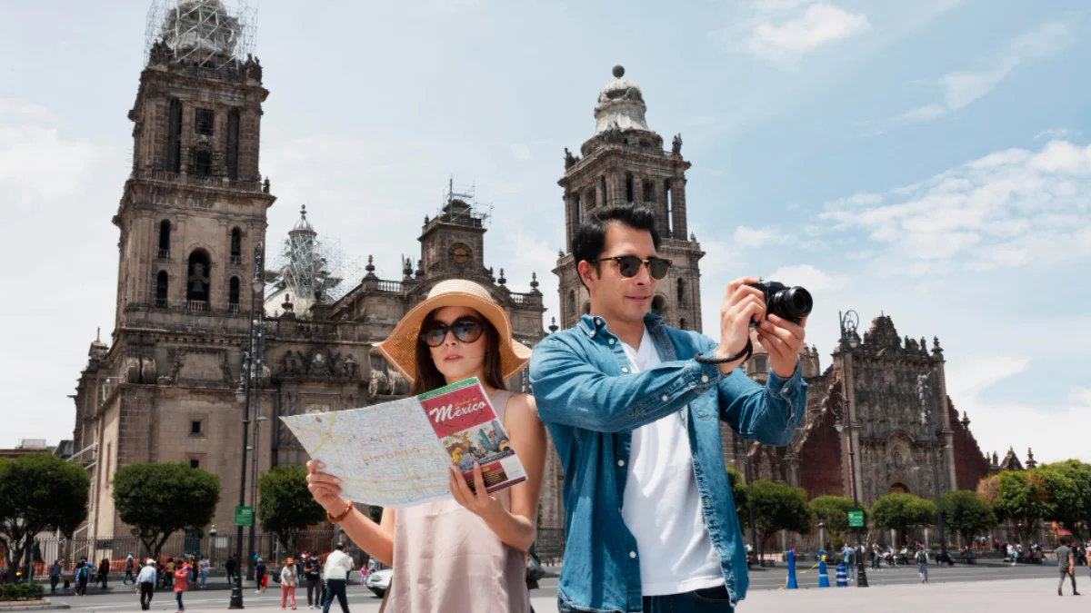 A couple stands in front of a historic cathedral