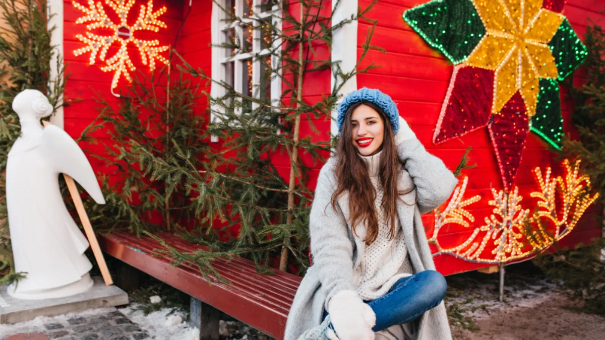 Woman in winter clothes sits on a bench