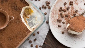 Tiramisu in a glass dish with a serving removed