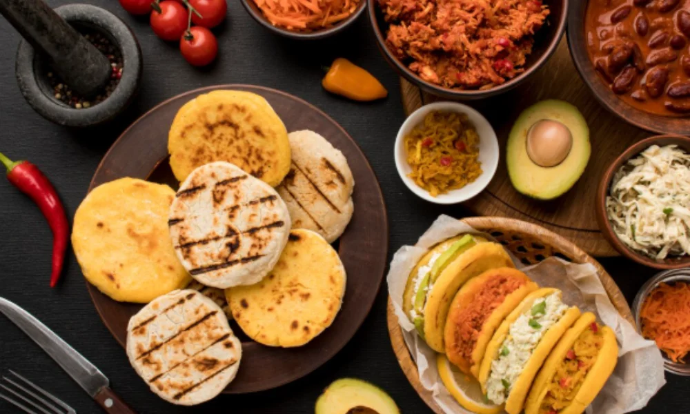 A colorful spread of arepas on a dark table-Places to Visit in Colombia