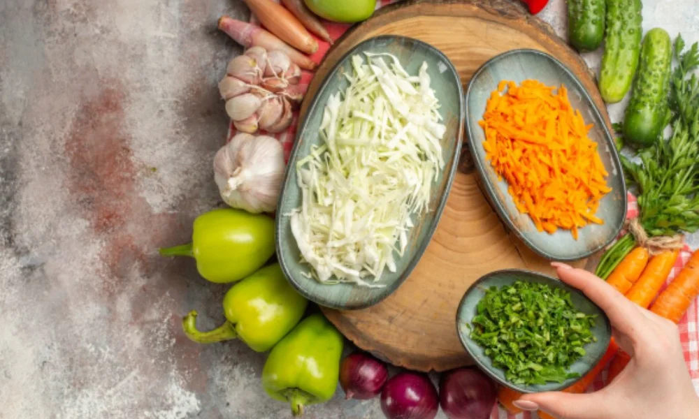 A rustic kitchen scene with assorted fresh vegetables-easy coleslaw recipe