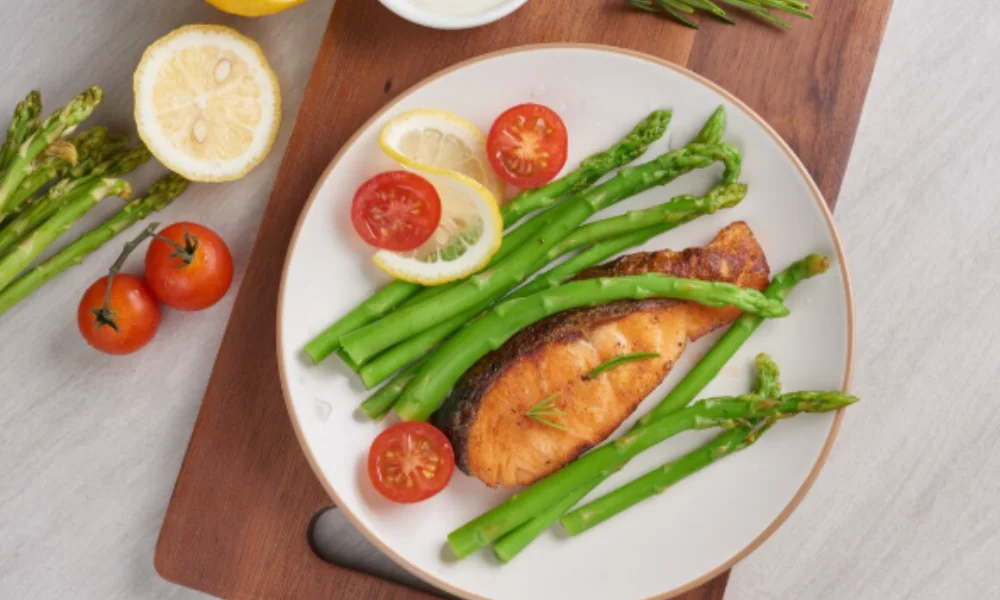 A plate with grilled salmon, asparagus, lemon slices-family easy dinner recipes