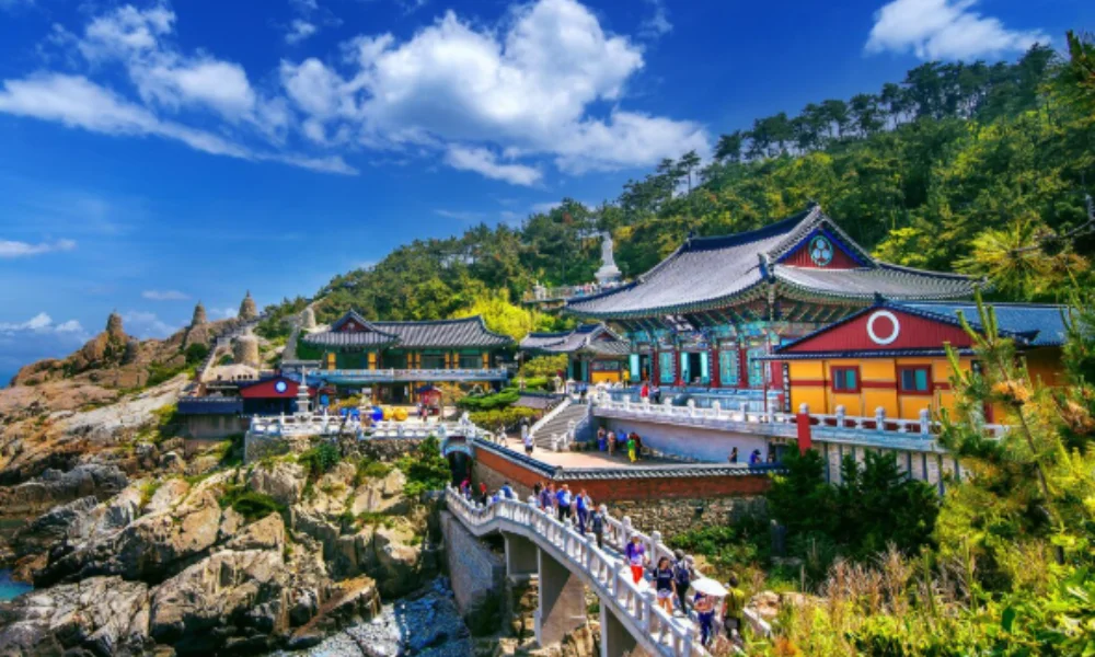 Scenic view of a colorful Buddhist temple on a rocky coastline