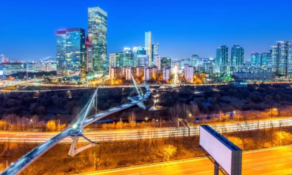 Night cityscape with illuminated skyscrapers against a deep blue sky-places to visit in washington state