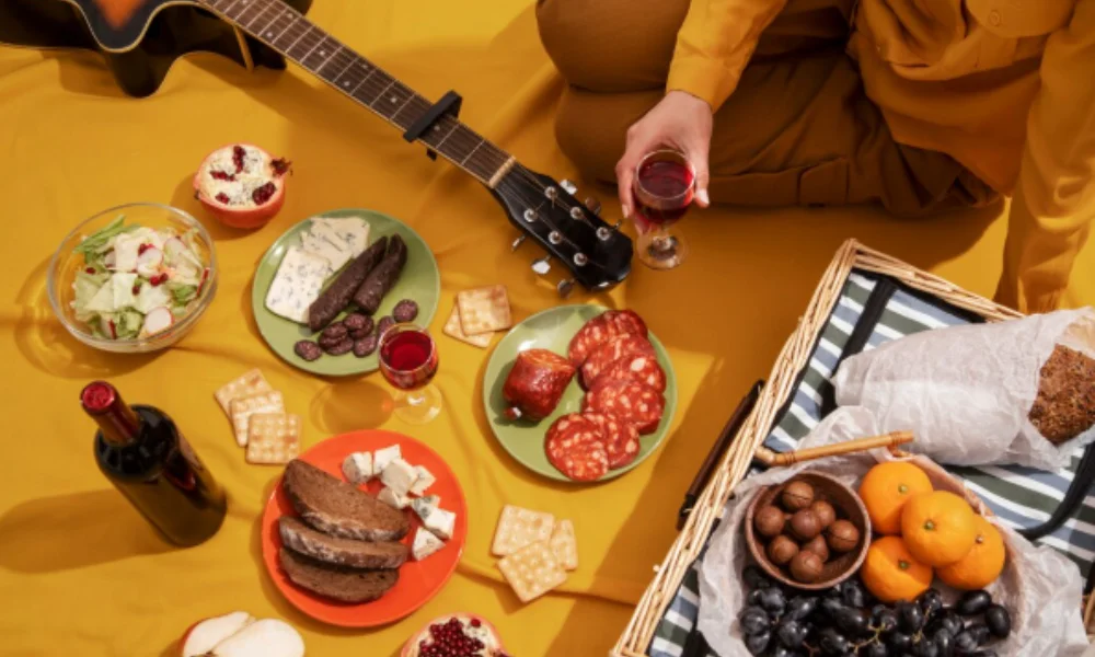 A picnic scene on a yellow blanket with an acoustic guitar-places to visit in argentina