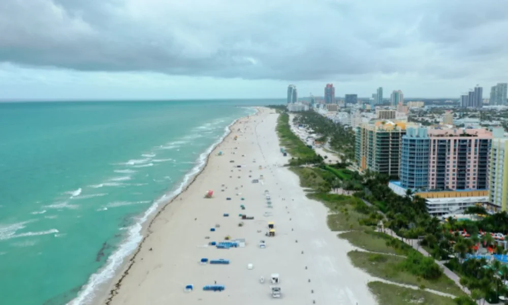 Aerial view of a vast beach with light sand and turquoise water-florida places to visit
