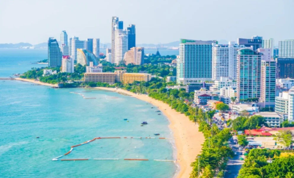 A coastal cityscape with tall skyscrapers lining a curved sandy beach-places to visit on the east coast