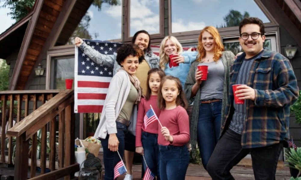 A diverse group of smiling adults and children stand on a porch-washington dc travel guide