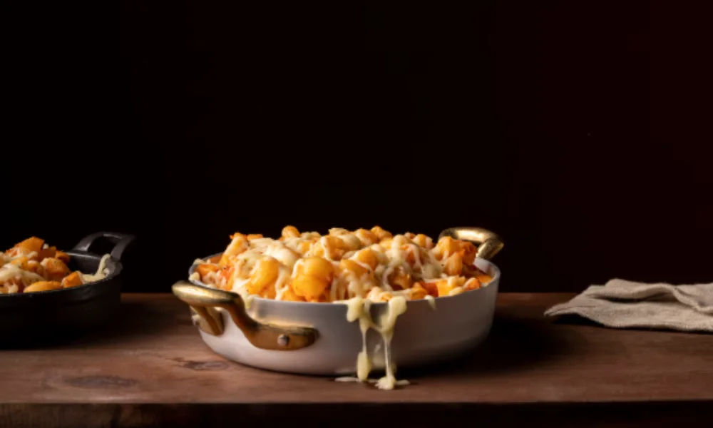 A dish of baked gnocchi topped with melted cheese-easy baked mac and cheese recipe