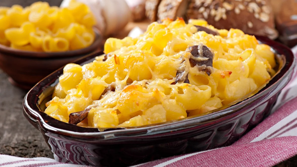 A baked macaroni and cheese dish in a black casserole