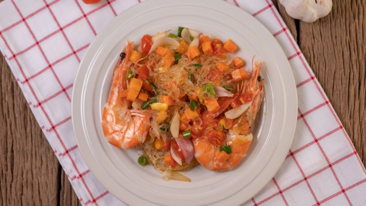 A plate of shrimp and glass noodle salad with diced vegetables
