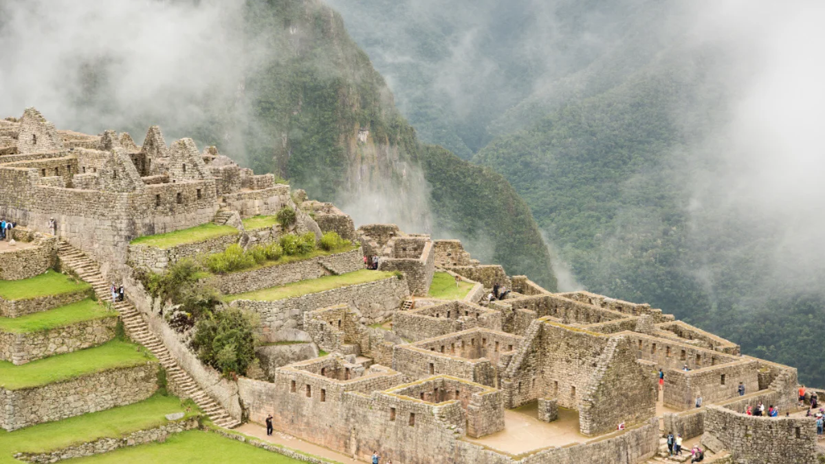 Machu Picchu shrouded in mist, showcasing ancient stone structures and terraces