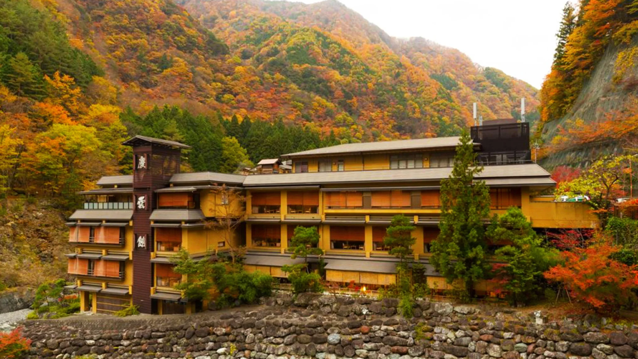A mountain building surrounded by vibrant autumn foliage, showcasing warm colors of fall against a scenic backdrop.