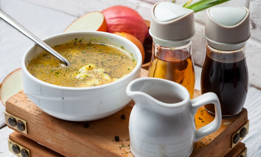 A bowl of soup with herbs and spices