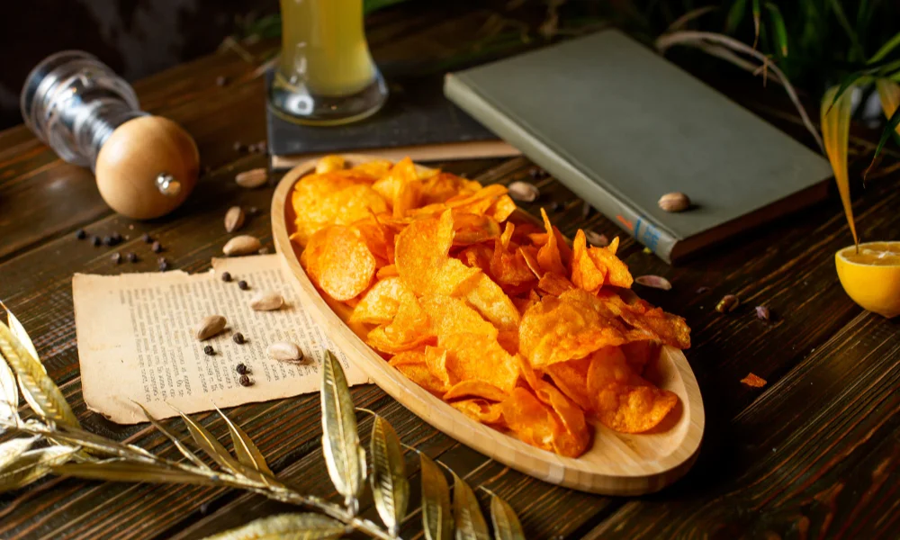 A wooden tray of crispy orange chips