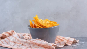 A gray bowl of orange corn chips