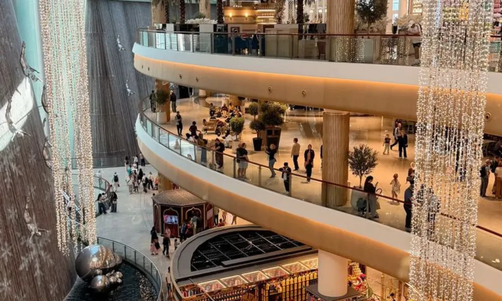 5 must visit places in Dubai showcases the expansive interior of Dubai Mall, featuring multi-level luxury shopping areas, indoor waterfalls, and light displays.