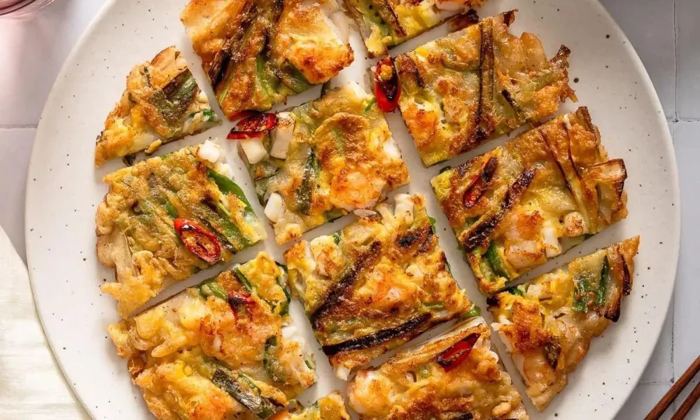 A top-down view of crisp, golden-brown Korean seafood scallion pancake-Korean Food Recipes