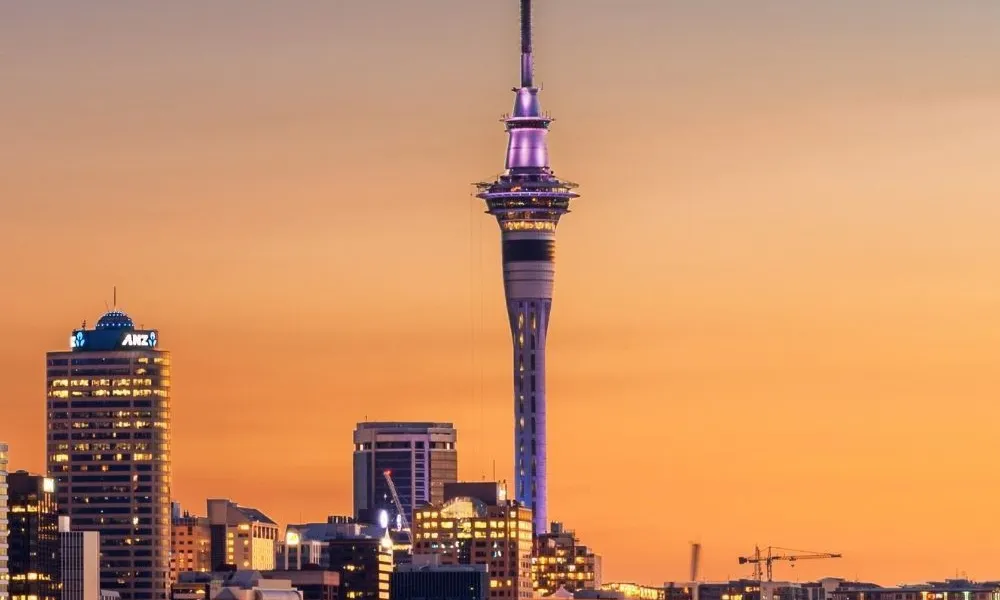 iconic Auckland Sky Tower skyline at dusk for Best Places to Visit in New Zealand.