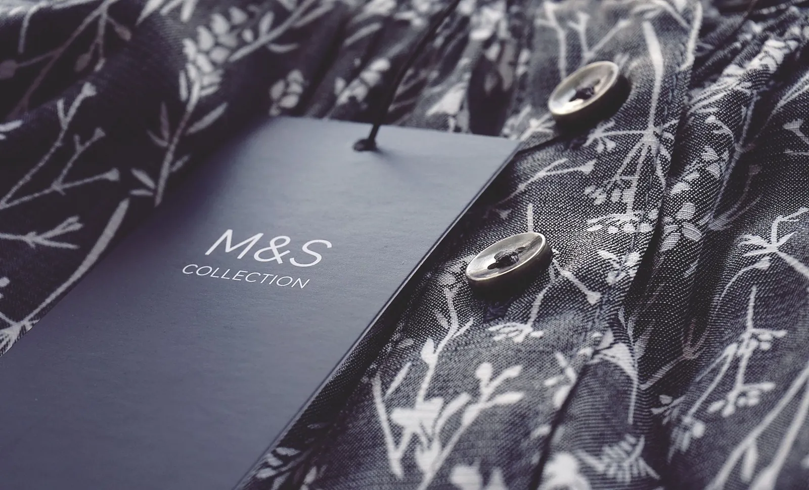 A close-up of a clothing label on a luxury garment detailing the fabric composition.