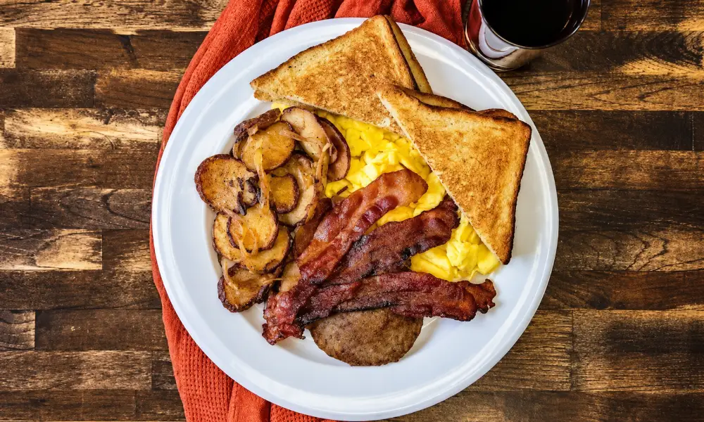breakfast plate with bacon, eggs, potatoes, and toast for best restaurants in Seneca.