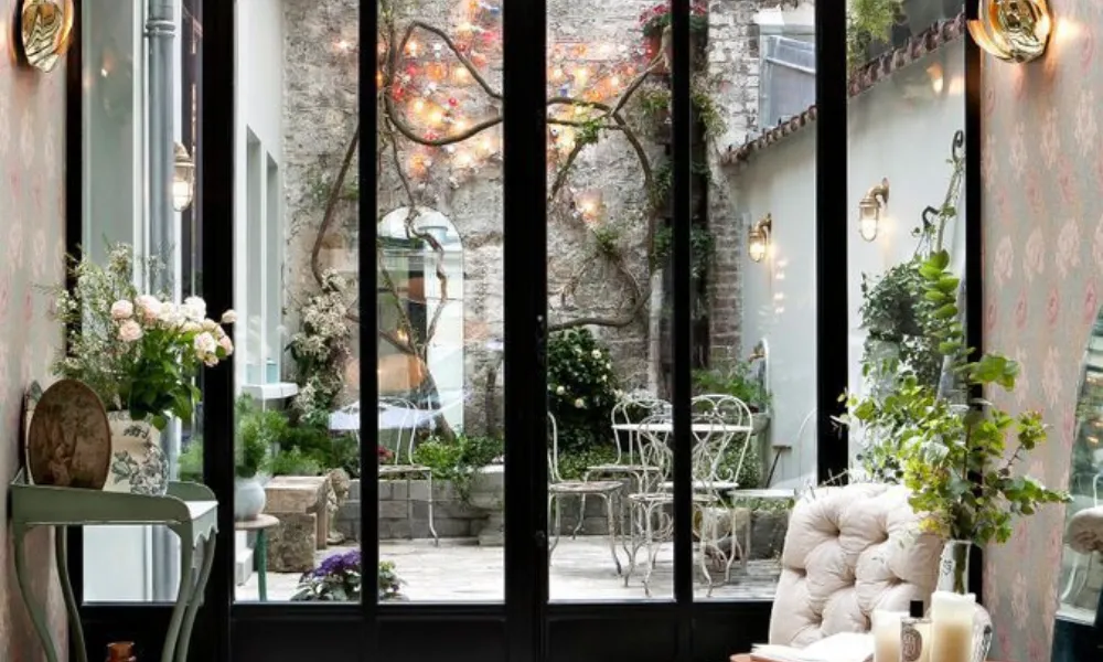 Boutique hotel courtyard garden interior at Hotel Henriette for Best Hotels in Paris.