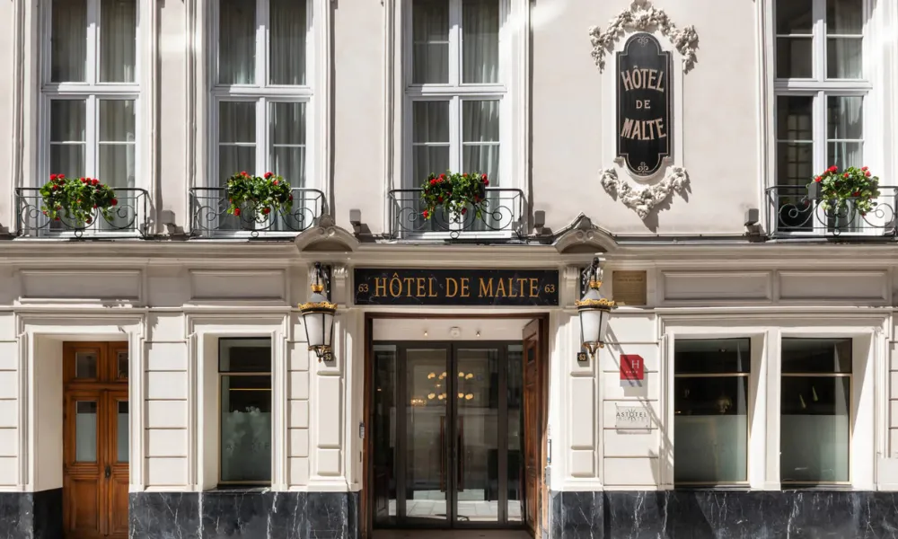 Historic luxury hotel entrance at Hôtel de Malte in central Paris for Best Hotels in Paris.