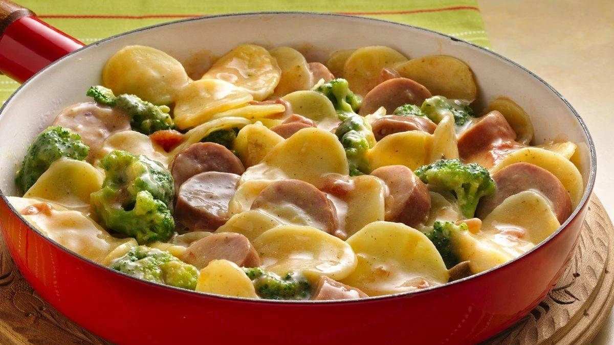 Sliced potatoes, sausage, and broccoli florets coated in a creamy sauce-One Pot Dinner Recipes